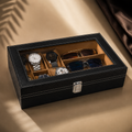 Luxury black watch organizer with cushioned slots and clear lid, displaying watches and sunglasses