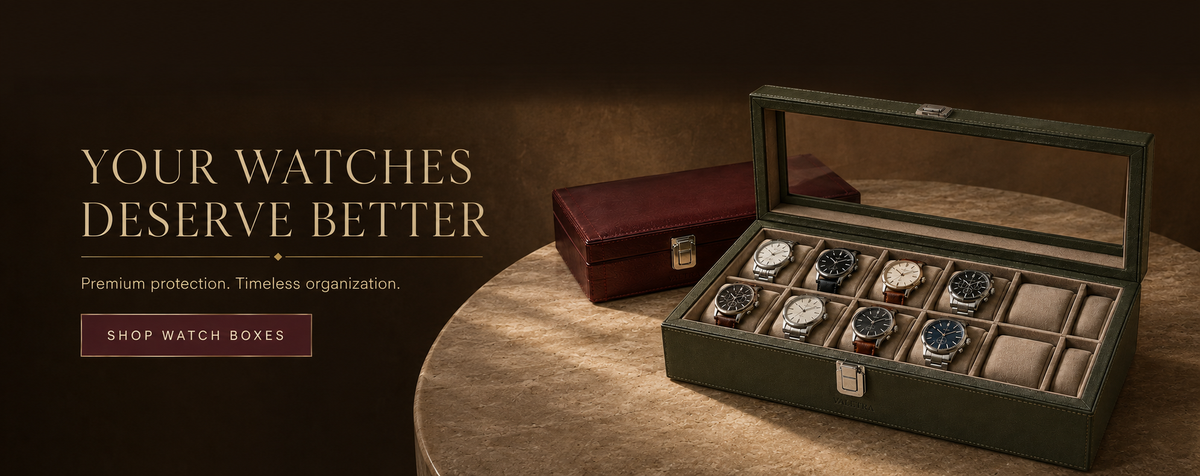 Luxury watch box with clear lid and cushioned compartments holding multiple watches, premium organization